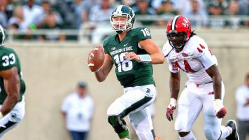 Michigan St. QB Connor Cook eludes Jacksonville St. DE LaMichael Fanning in the first half of yesterday's 2014 season opener at Spartan Stadium. MSU would go on to win, 45-7.  Mike Carter - USA Today
